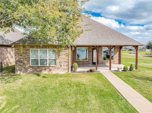 view of front of house featuring a front lawn and a patio