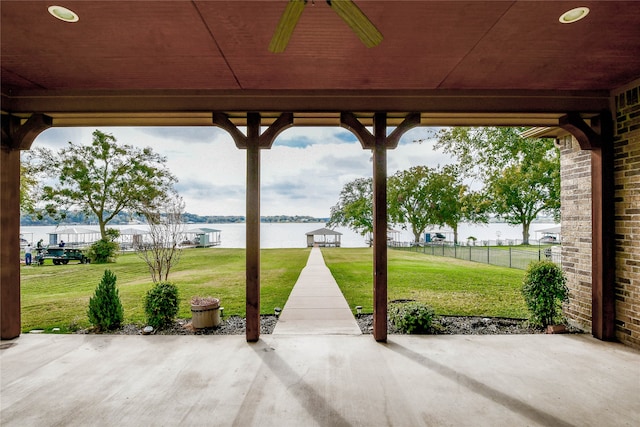 view of patio / terrace featuring a water view and ceiling fan