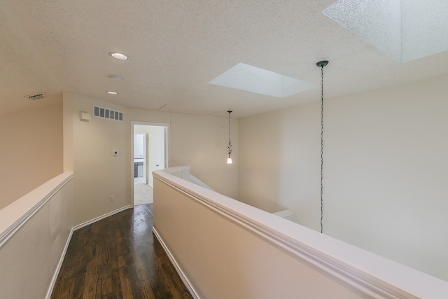 unfurnished room featuring a notable chandelier, light tile patterned flooring, and a textured ceiling