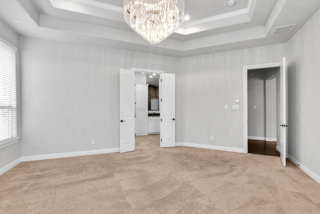 unfurnished bedroom with multiple windows, crown molding, and light carpet