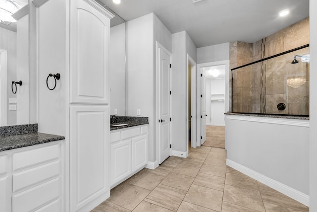 bathroom with an enclosed shower and vanity