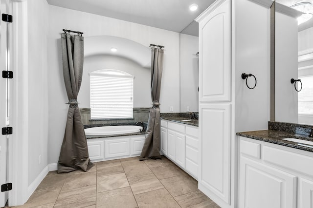 bathroom with a bath and vanity