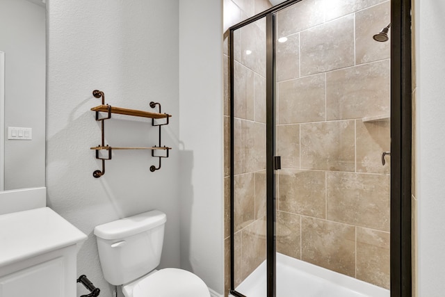 bathroom featuring toilet and a shower with door