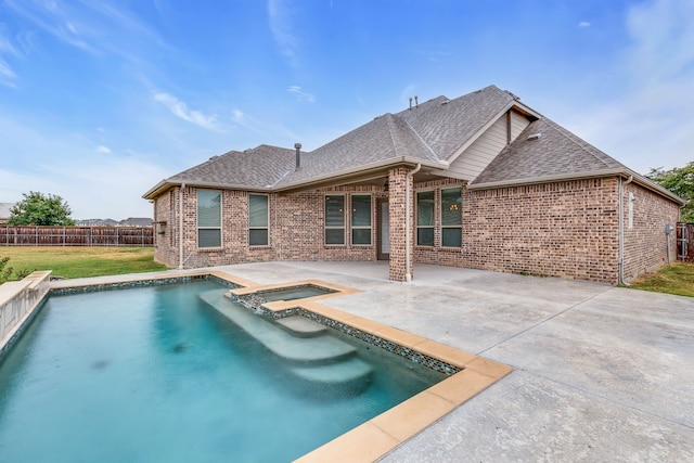 view of pool featuring a patio, an in ground hot tub, and a lawn