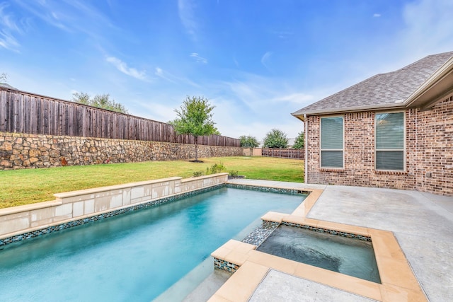 view of swimming pool with a yard and an in ground hot tub