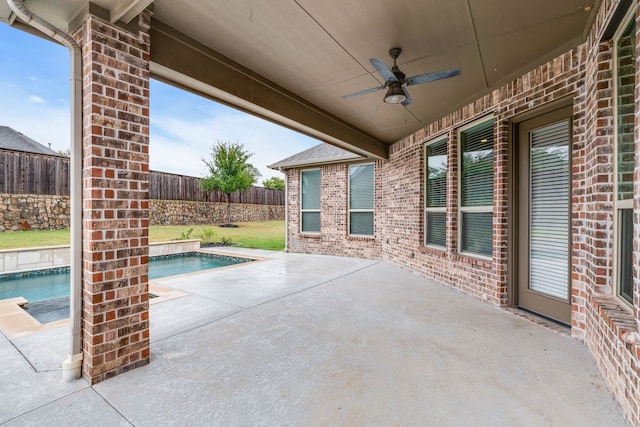 view of patio / terrace featuring ceiling fan and a fenced in pool