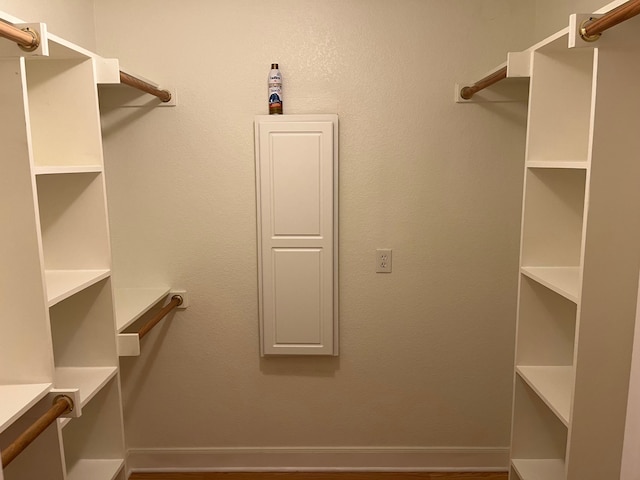 spacious closet featuring hardwood / wood-style flooring