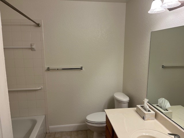 full bathroom with tiled shower / bath combo, vanity, toilet, and tile patterned floors