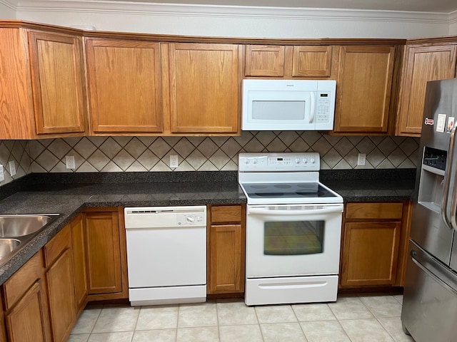 kitchen featuring decorative backsplash, white appliances, ornamental molding, and light tile patterned floors