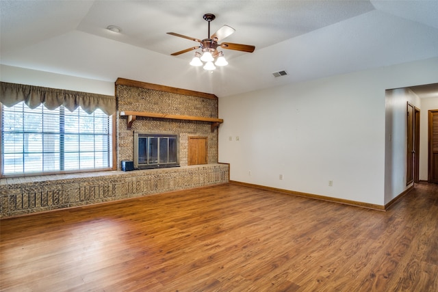 unfurnished living room featuring ceiling fan, a fireplace, hardwood / wood-style floors, and lofted ceiling