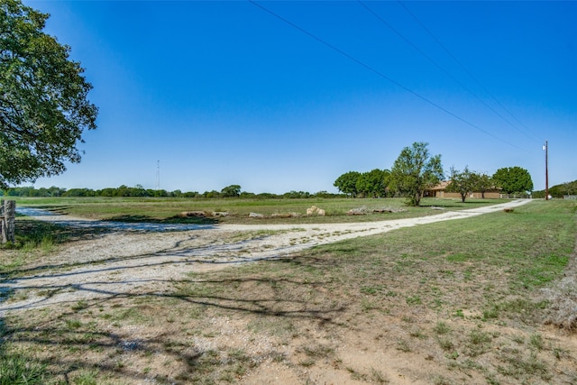 view of yard with a rural view