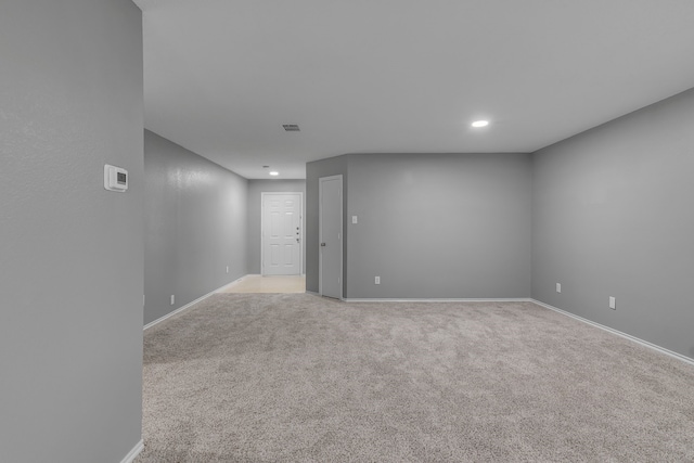 unfurnished room featuring light colored carpet