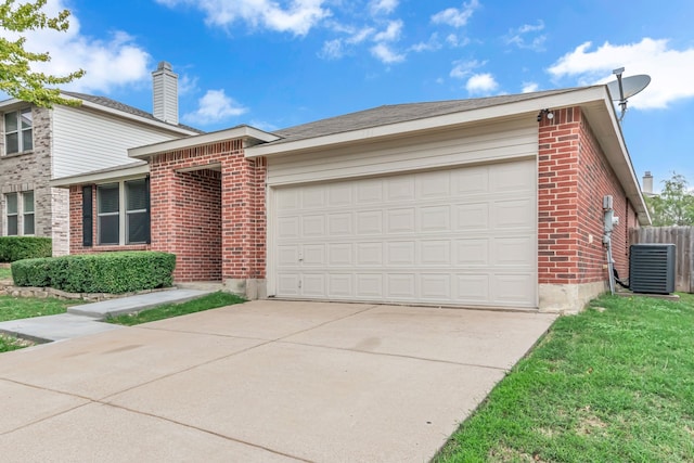 view of front of house with a garage, central AC, and a front lawn