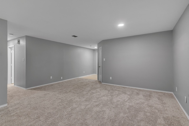 unfurnished room with light carpet