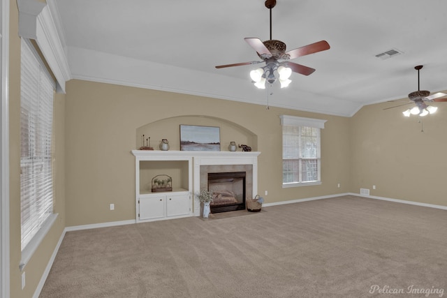 unfurnished living room featuring crown molding, light colored carpet, and ceiling fan