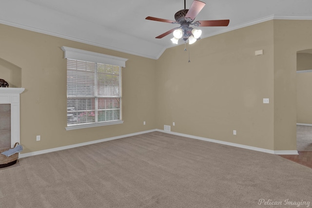 unfurnished living room featuring a tiled fireplace, ceiling fan, vaulted ceiling, ornamental molding, and light colored carpet