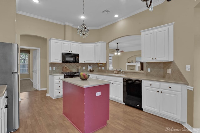 kitchen featuring sink, black appliances, light hardwood / wood-style flooring, and a kitchen island