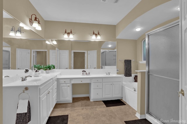 bathroom with vanity, an enclosed shower, and tile patterned floors