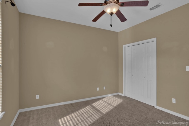 unfurnished bedroom with a closet, ceiling fan, and carpet flooring