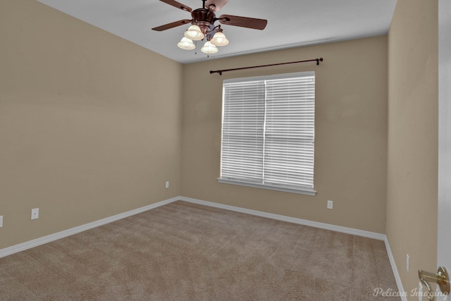 spare room featuring ceiling fan, light carpet, and plenty of natural light