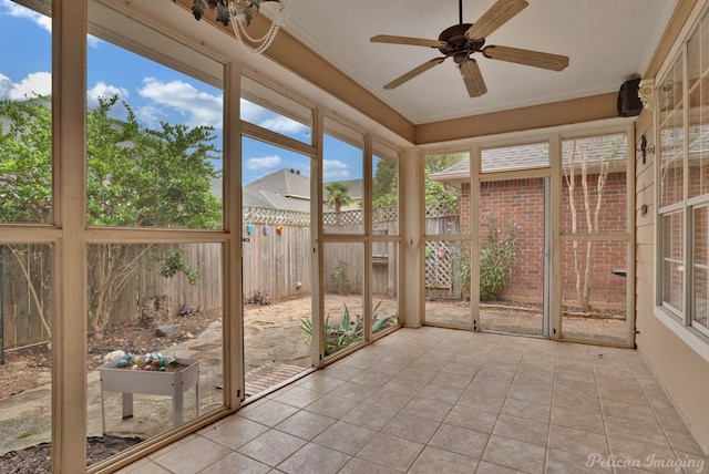 unfurnished sunroom with ceiling fan