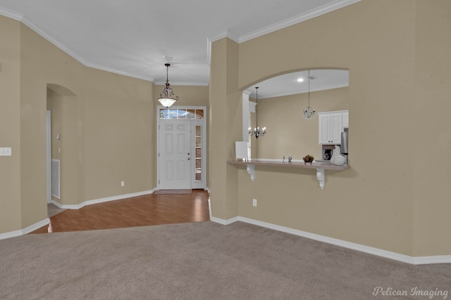 entryway featuring light carpet and crown molding