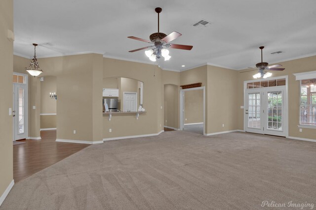 unfurnished living room featuring crown molding, carpet flooring, and ceiling fan