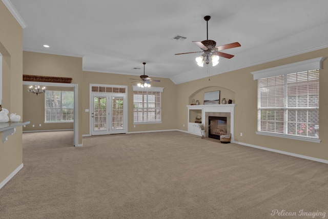 unfurnished living room featuring light carpet, crown molding, and ceiling fan with notable chandelier