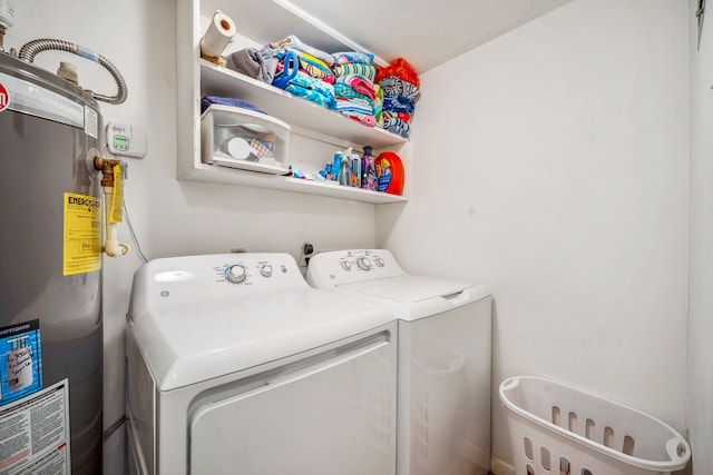 clothes washing area with gas water heater and washing machine and clothes dryer