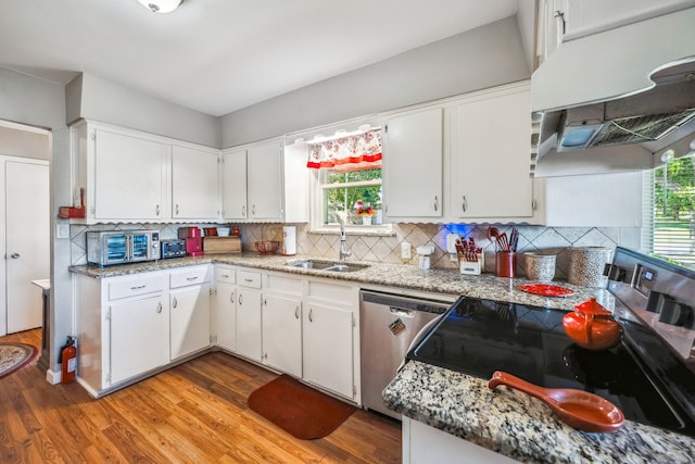 kitchen with a healthy amount of sunlight, white cabinetry, and stainless steel appliances