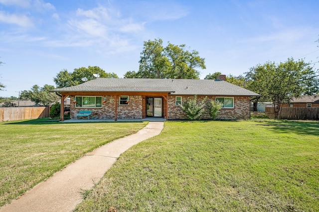 ranch-style house featuring a front yard