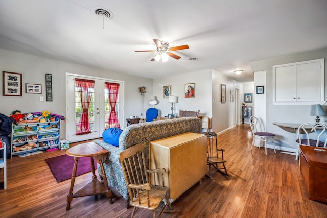 living room featuring hardwood / wood-style floors, ceiling fan, and french doors