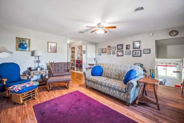 living room with ceiling fan and hardwood / wood-style floors