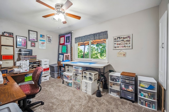 carpeted office featuring ceiling fan