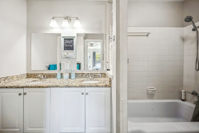 bathroom with vanity and tiled shower / bath combo