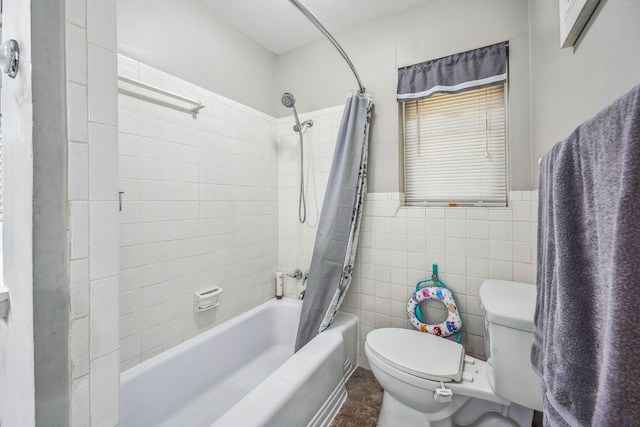 bathroom featuring tile walls, shower / tub combo with curtain, and toilet