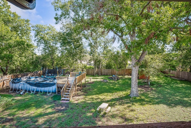 view of yard with a covered pool