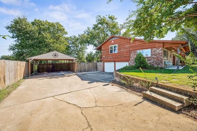 view of front of house with a carport, a front yard, and a garage