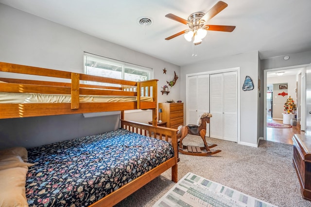 bedroom with ceiling fan, a closet, and carpet flooring