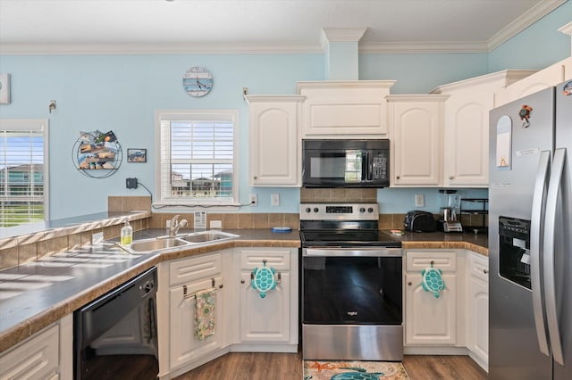 kitchen featuring a healthy amount of sunlight, black appliances, and white cabinets