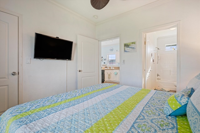 bedroom with ornamental molding and ensuite bathroom