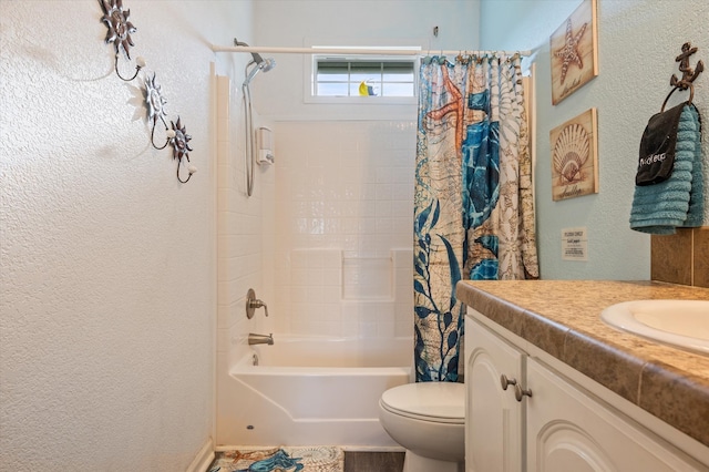 full bathroom with shower / tub combo with curtain, vanity, and toilet