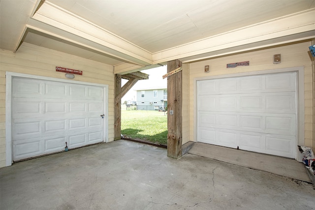 garage featuring wood walls