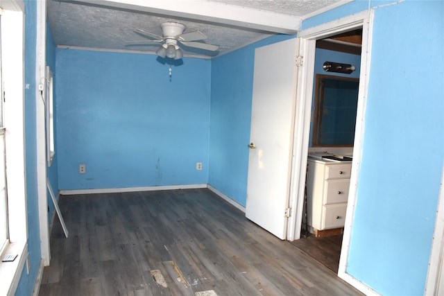 spare room with a textured ceiling, dark wood-type flooring, and ceiling fan