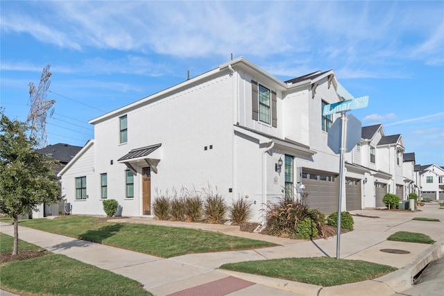 view of home's exterior featuring a garage and a lawn