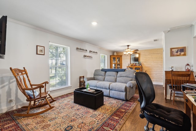 living room with crown molding, hardwood / wood-style flooring, and ceiling fan