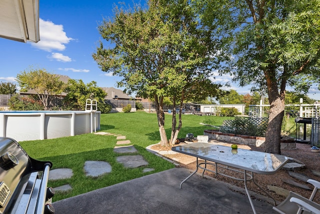 view of yard featuring a patio area and a fenced in pool