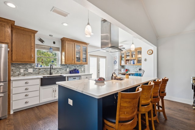 kitchen with island exhaust hood, a center island, sink, and dark hardwood / wood-style floors