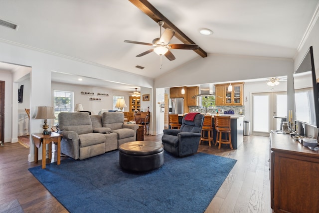 living room with ornamental molding, vaulted ceiling with beams, wood-type flooring, and ceiling fan