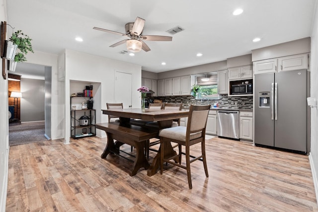 dining room featuring light hardwood / wood-style floors and ceiling fan